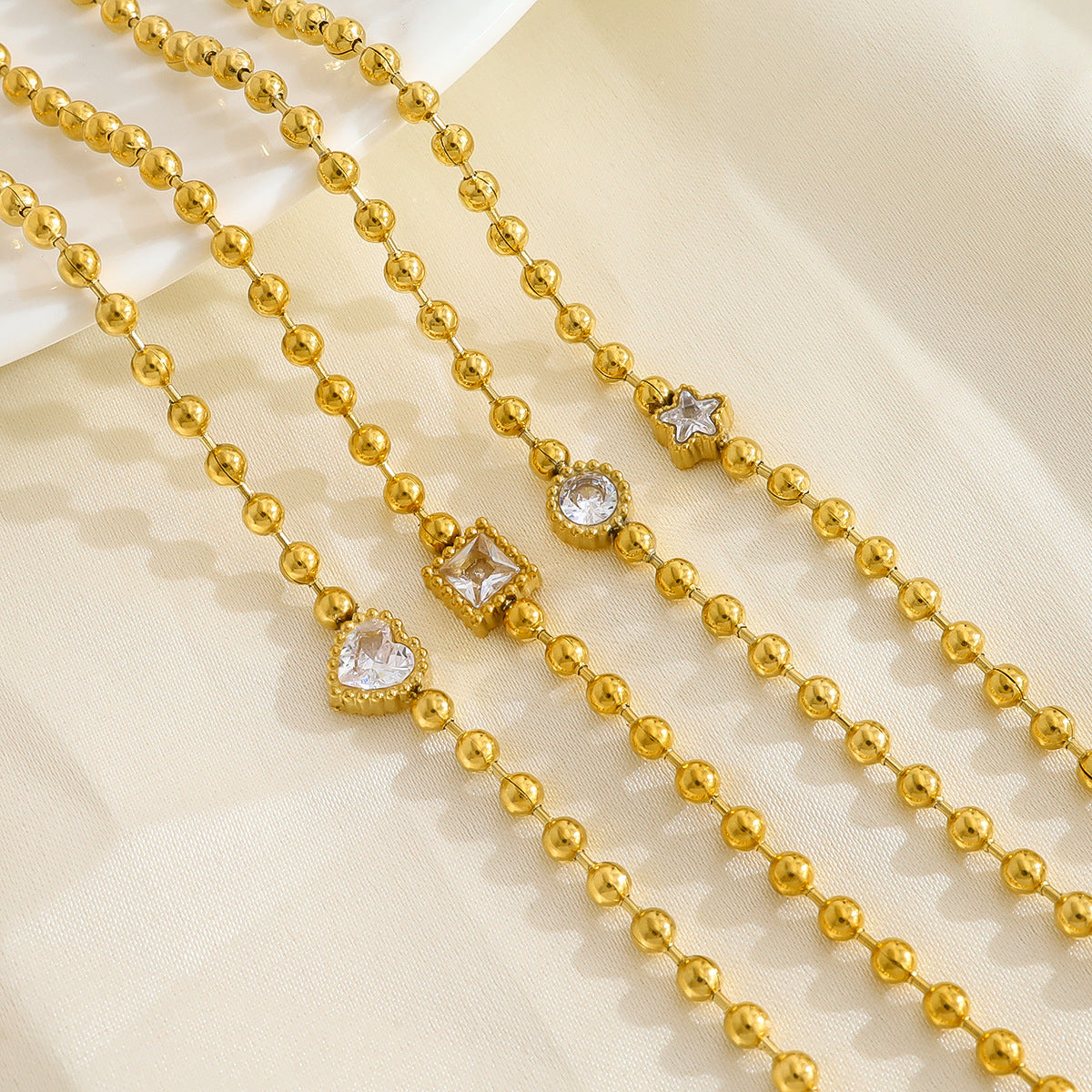 18K Gold Plated Titanium Steel Fashion Layered Small Gold Bead Chain Bracelet Set – Simple Geometric Designs with Crystal Inlays, Heart and Star Pendants